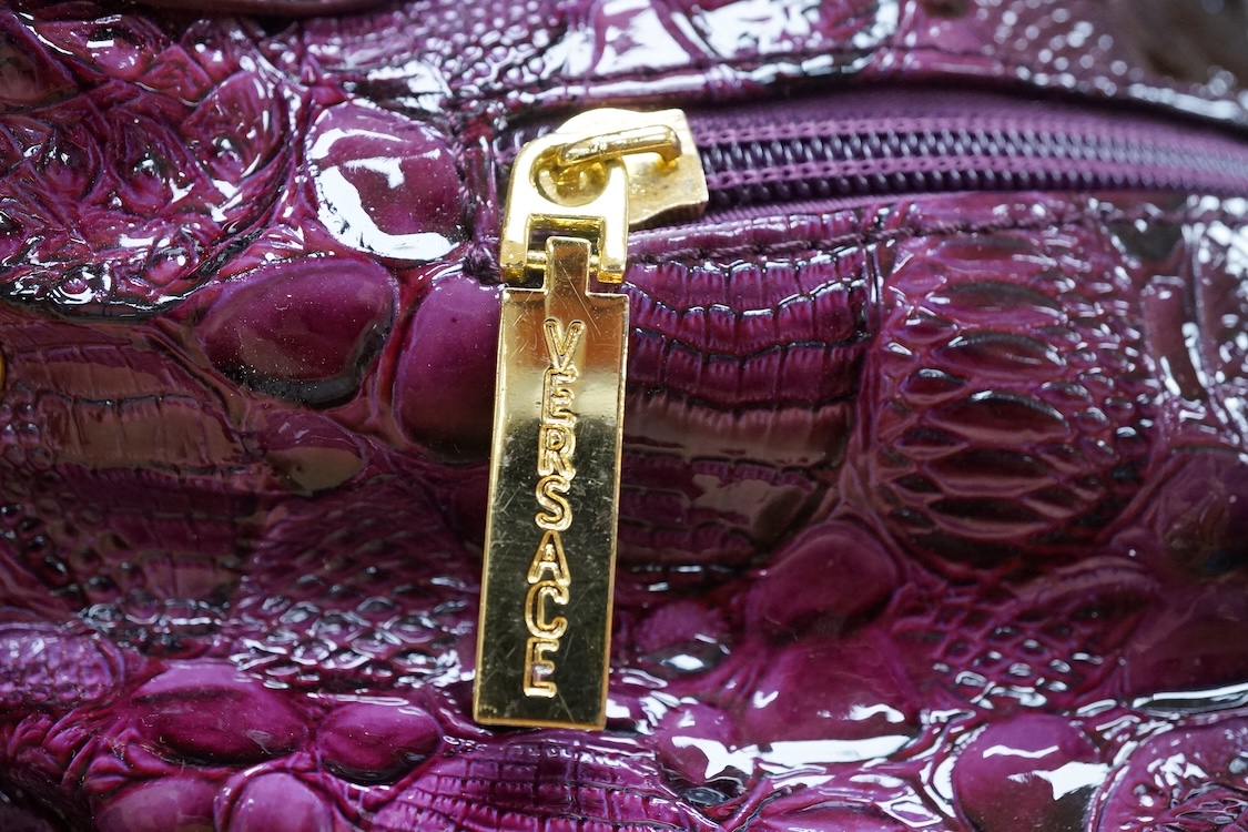 A purple patent Versace large handbag, approximately 41cm wide
